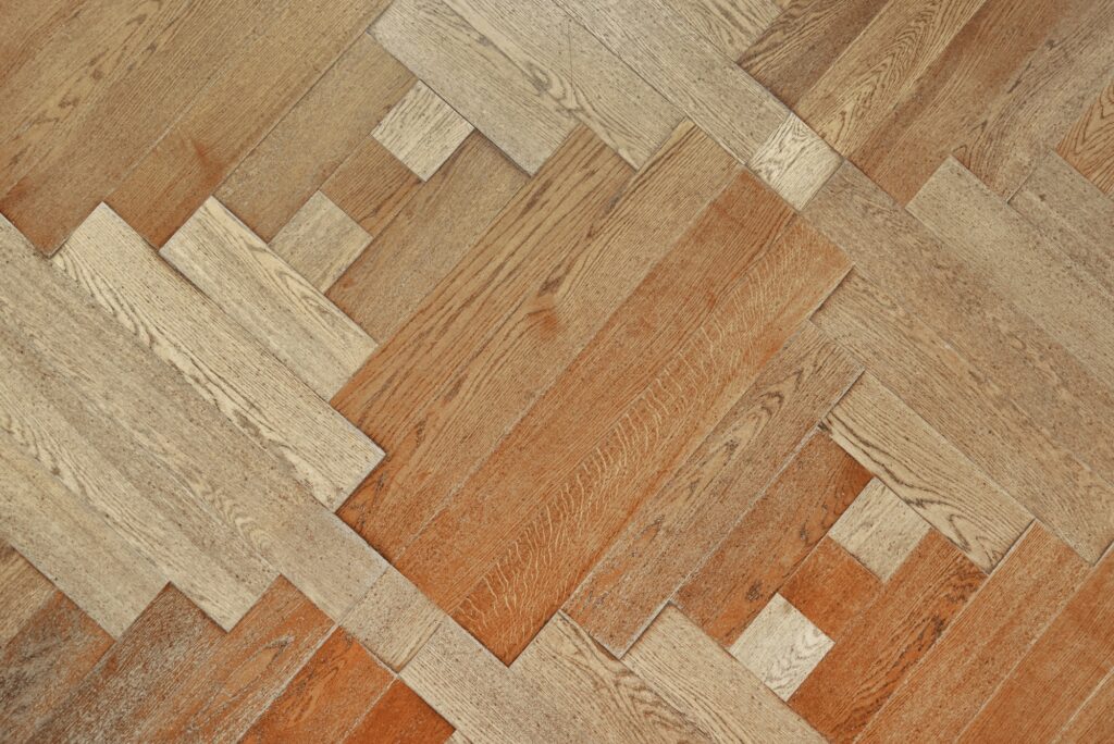 Wooden floor with pattern made of thin planks. Parquet background