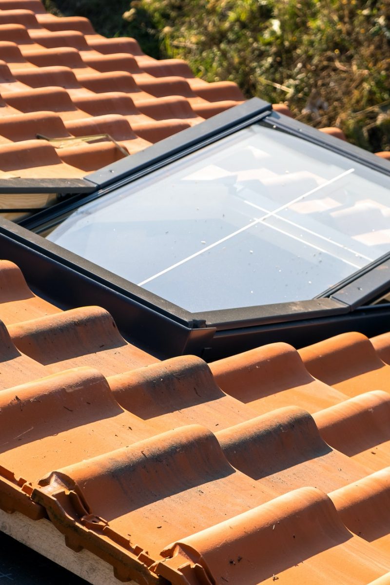 Overlapping rows of yellow ceramic roofing tiles mounted on wooden boards